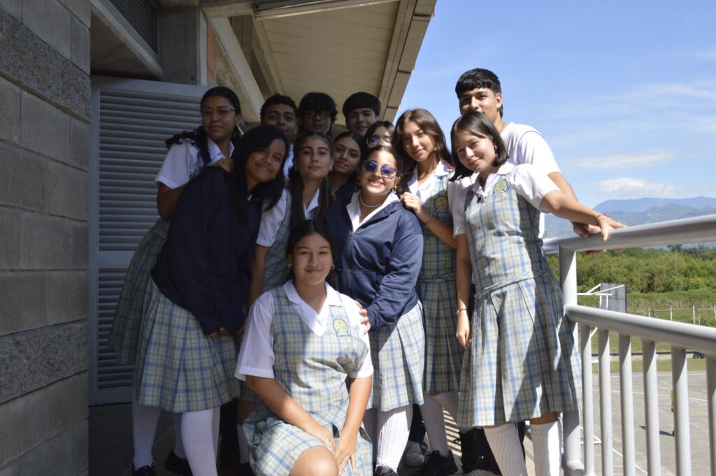 Grupo de estudiantes del colegio en un balcón, con las montañas al fondo